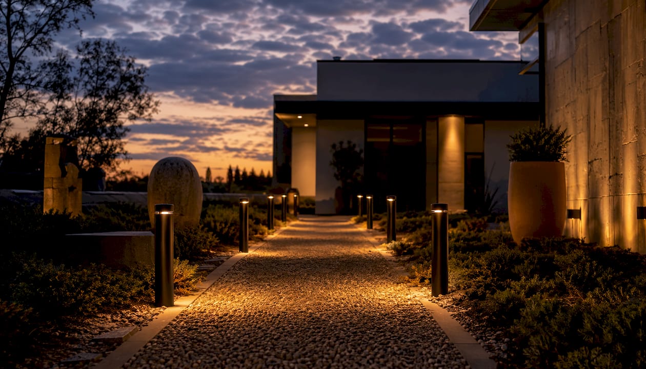 Path Lighting Explained: Safe, Stylish Walkways for Homeowners Modern bollard lights illuminating a wide walkway