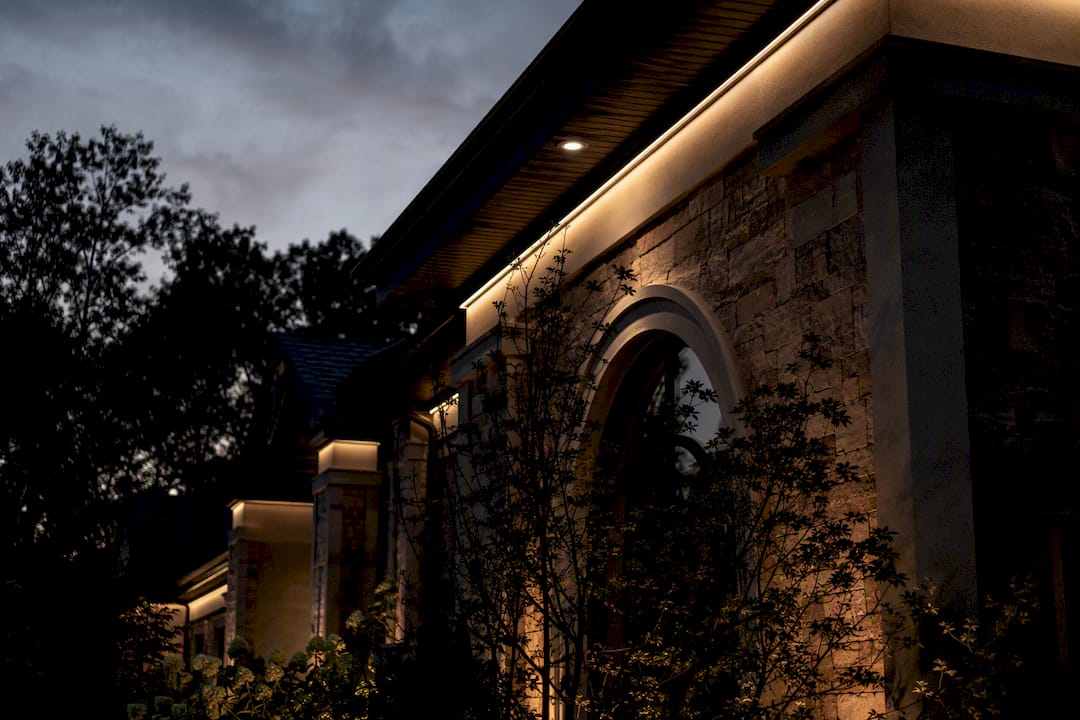 Hiding Landscape Lighting Wires: A Homeowner's Code Guide LED track lighting seamlessly concealed on roofline