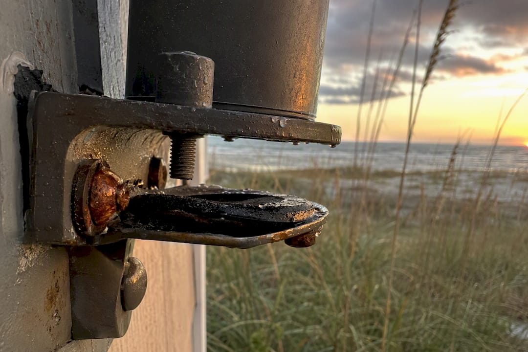 Coastal Lighting Corrosion: What to Demand From Any Fixture Corroded coastal lighting bracket and gasket failure close-up