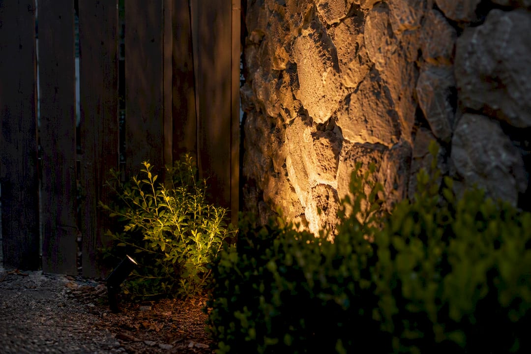 What Is Spread Lighting Outdoors? A Homeowner's Guide Outdoor LED light beam widening on garden wall