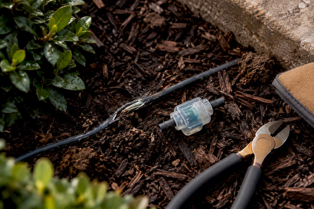 Chewed outdoor wire beside repair connector