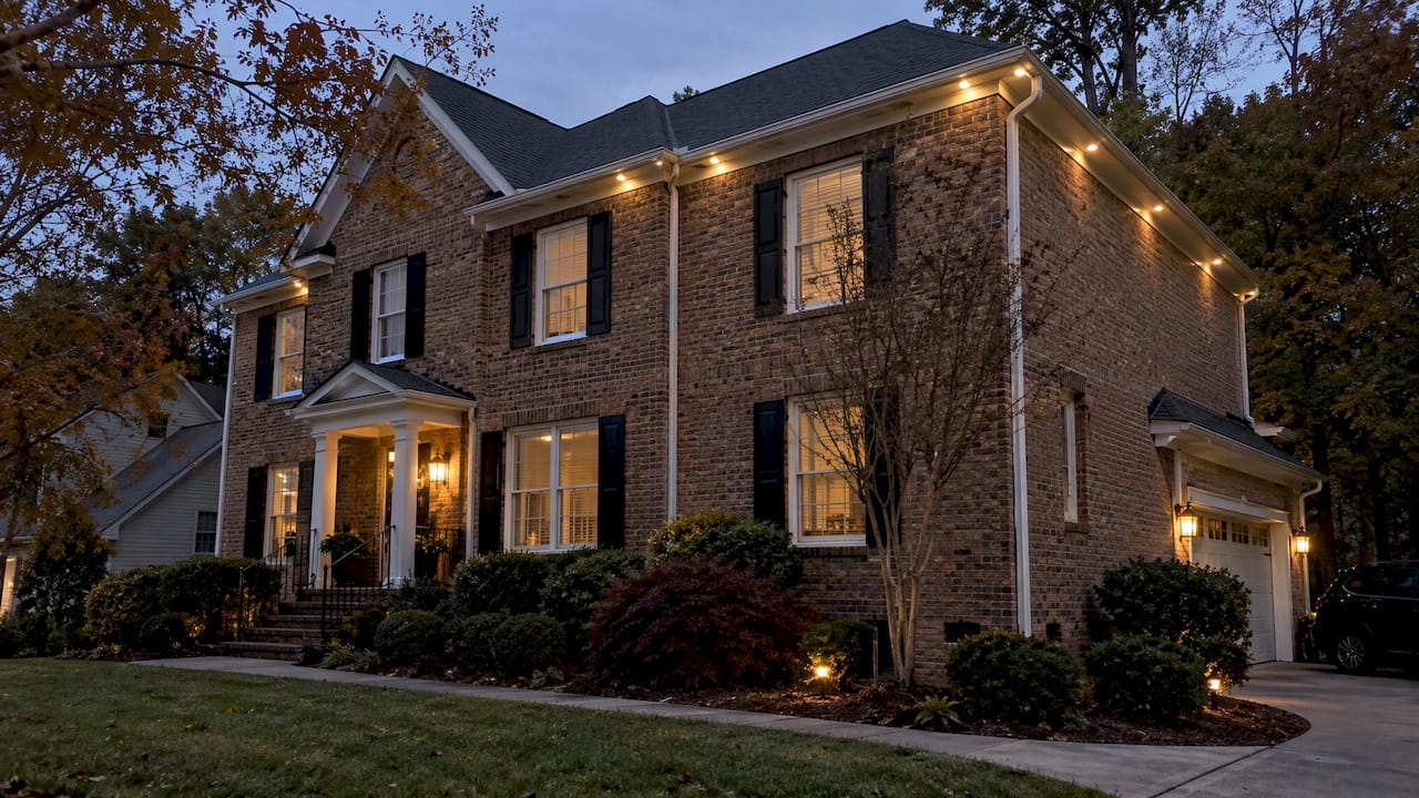 Permanent LED roofline lights installed above gutters