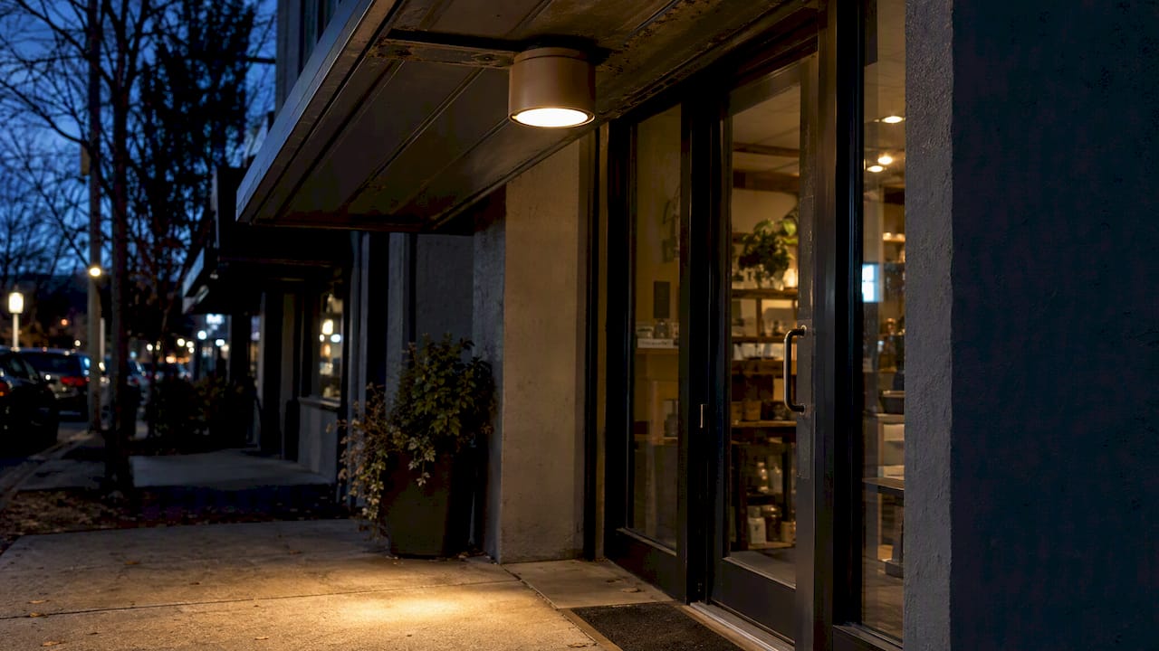 Small Retailers: 5 DarkSky Backed Rules for Storefront Lighting Design Shielded downlight beneath storefront canopy