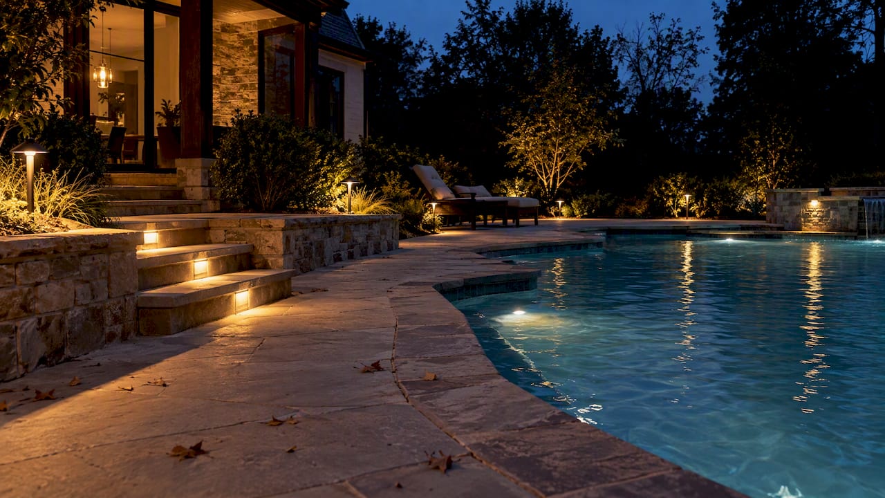 Layered lighting across pool deck steps
