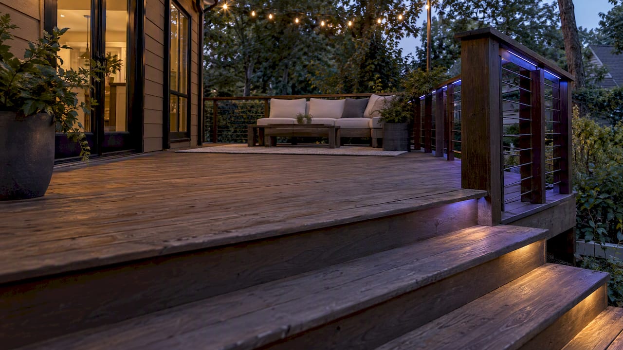 Soft color lighting along deck steps and rails